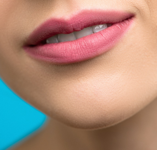 Close-up of a white woman's chin and lips with mouth slightly open and using pink lipstick