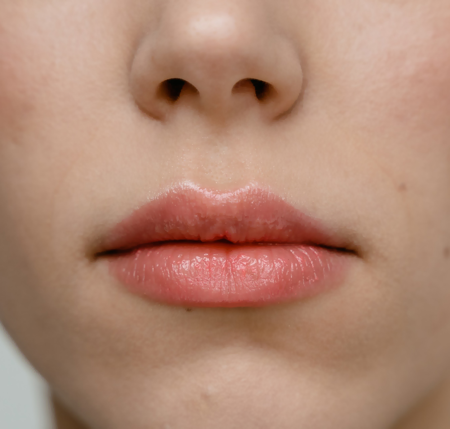 Close-up of a white woman's lips and nose without any hairs on around the lips area