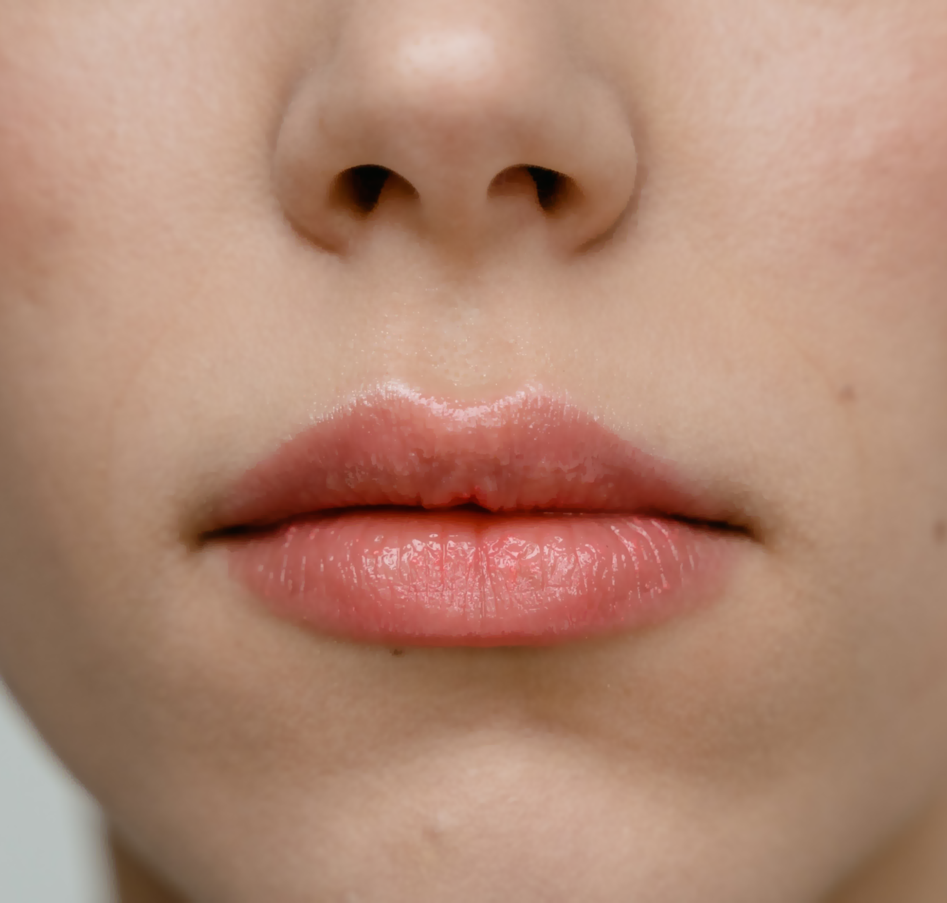 Close-up of a white woman's lips and nose without any hairs on around the lips area